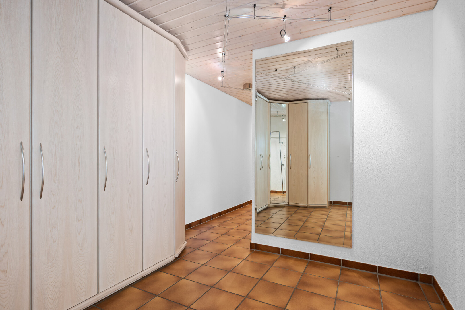 tiled empty room featuring wooden ceiling