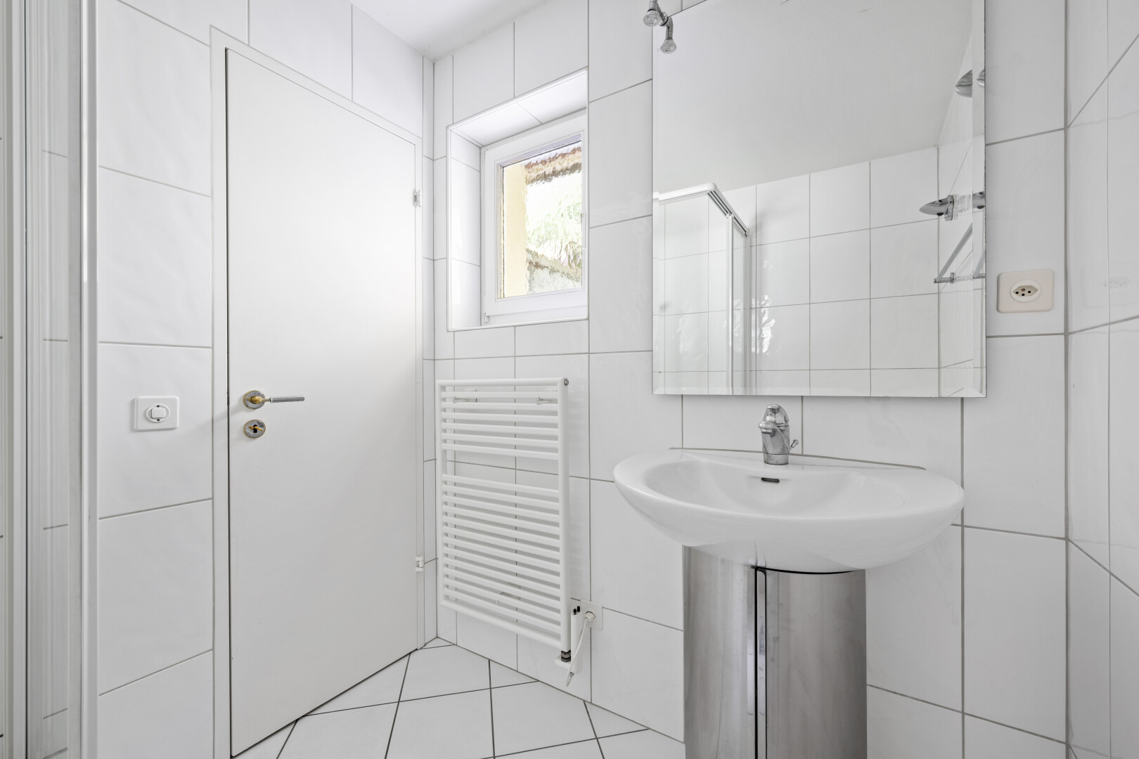 full bathroom featuring tile walls, radiator heating unit, tiled shower, and light tile patterned flooring