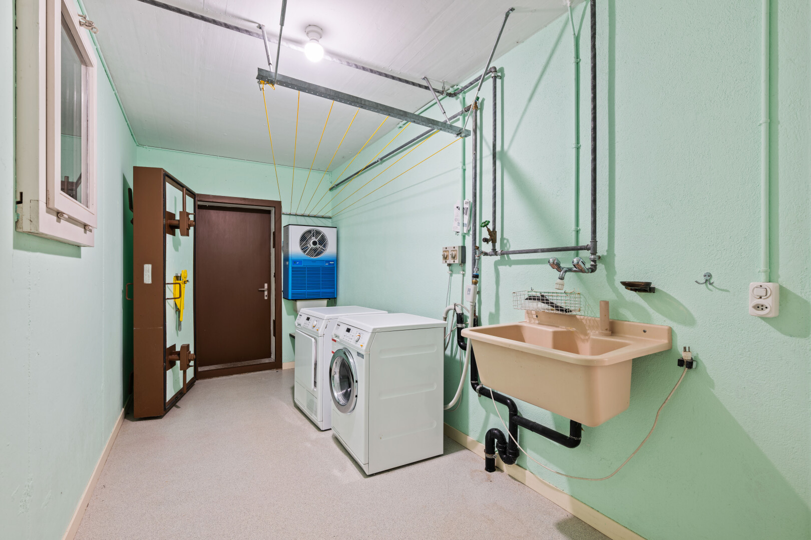 laundry area featuring separate washer and dryer and light colored carpet