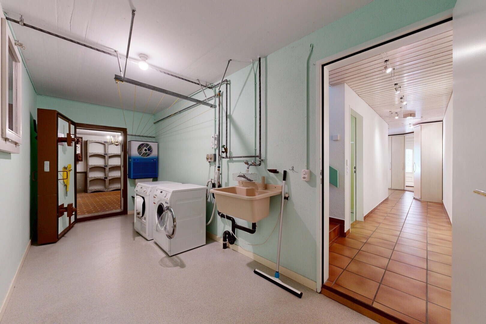 buanderie avec garage, drywall, cloison sèche, inside property, et light floor