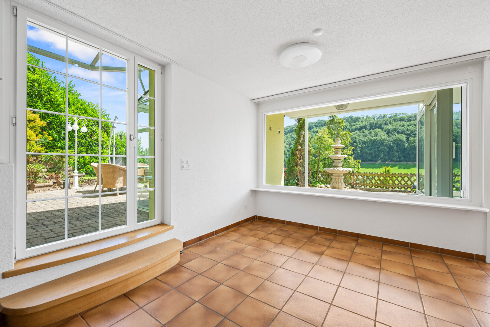tiled empty room featuring baseboards