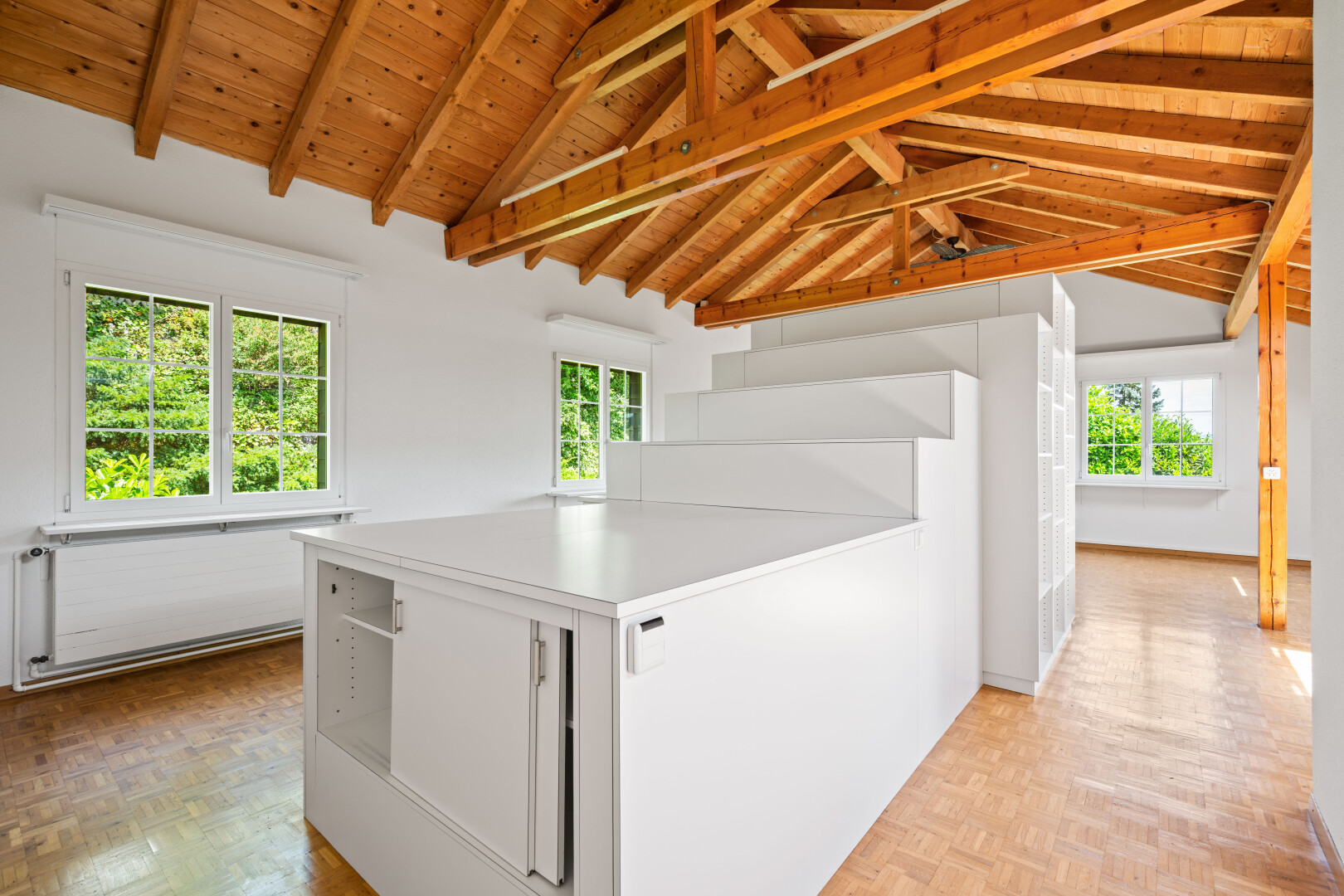 interior space with white cabinetry, light countertops, parquet floors, a wood ceiling with exposed beams, and a peninsula