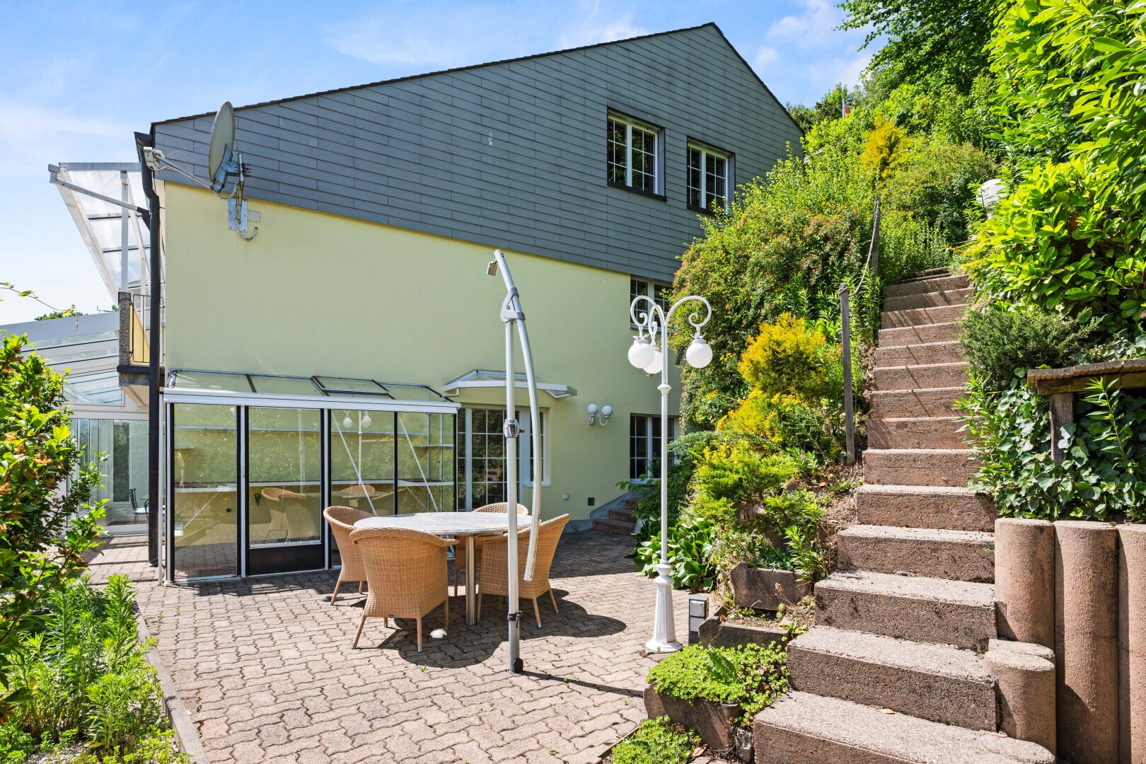 view of home with outdoor dining area, stucco siding, and a patio
