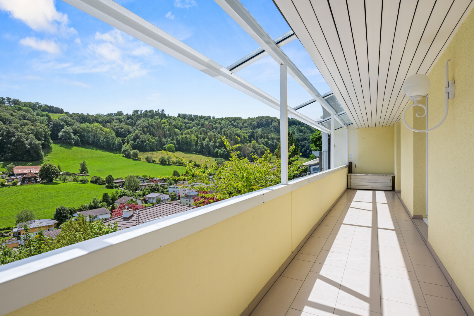 balcony featuring a forest view