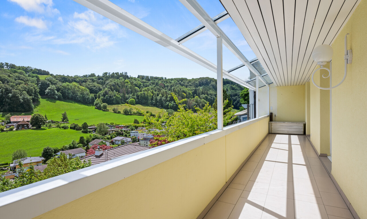 balcony featuring a forest view