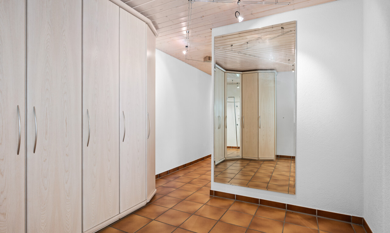 tiled empty room featuring wooden ceiling