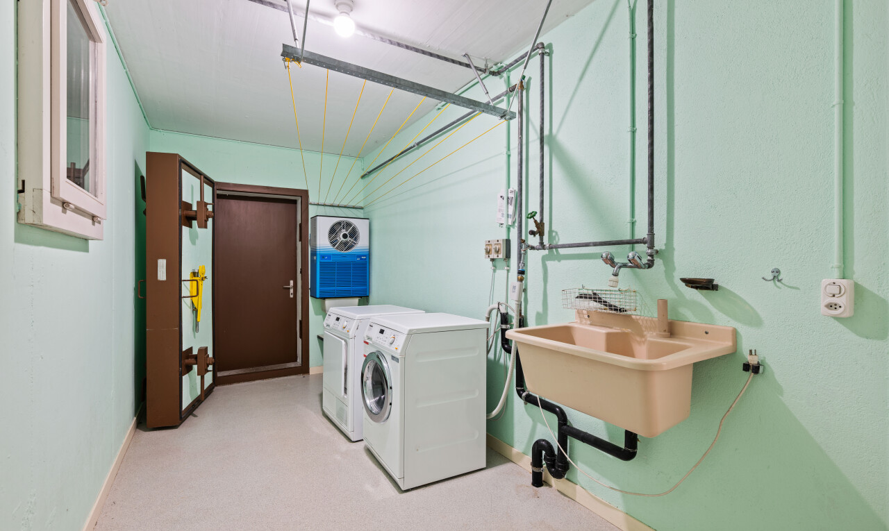 laundry area featuring separate washer and dryer and light colored carpet