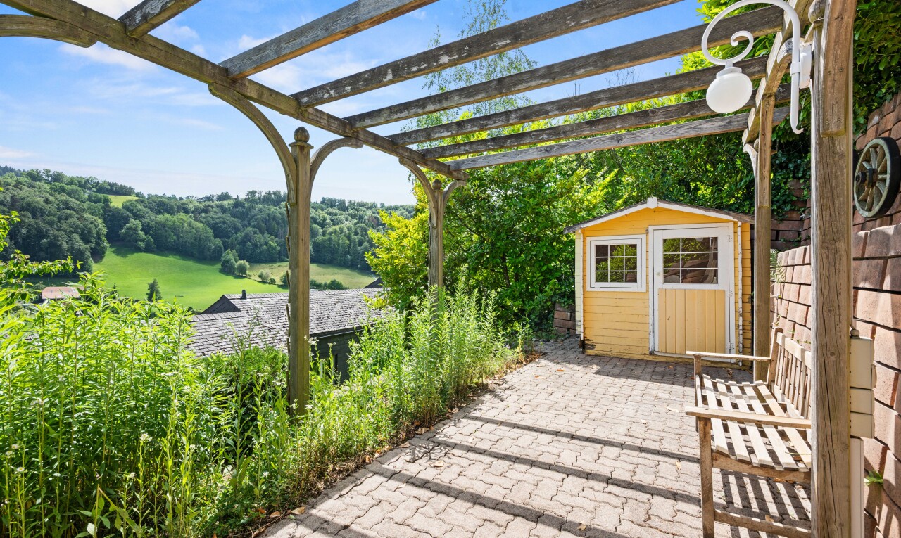 patio / terrace featuring a storage unit, a pergola, and a patio