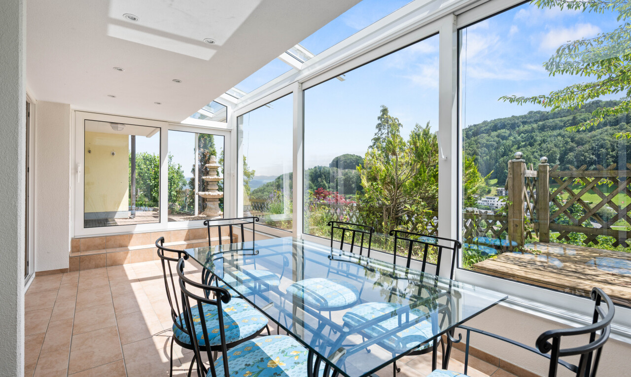 dining area featuring a skylight and light tile patterned floors