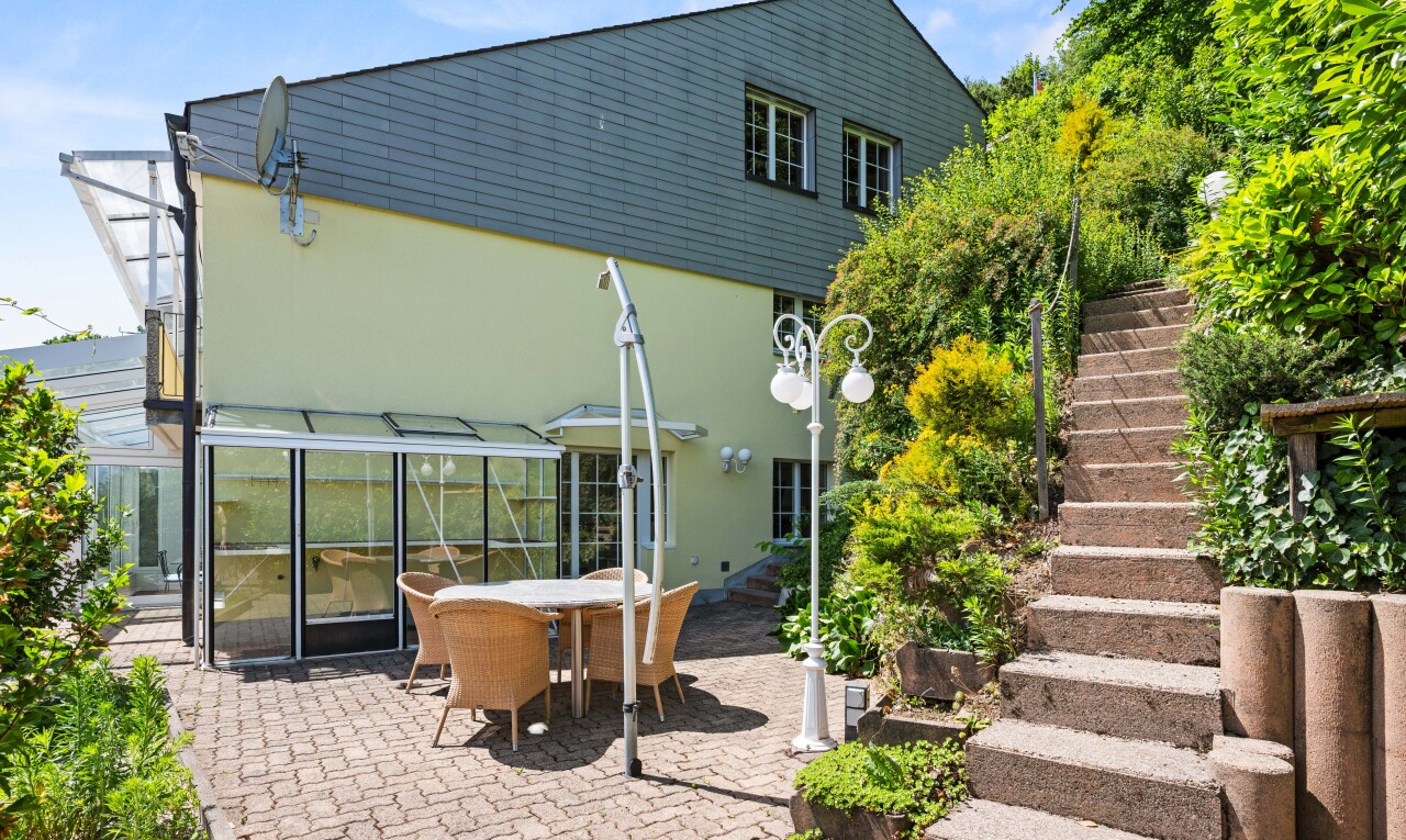 view of home with outdoor dining area, stucco siding, and a patio