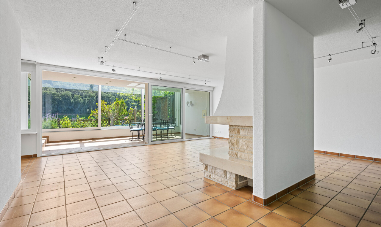 unfurnished room featuring rail lighting, light tile patterned floors, and a textured ceiling