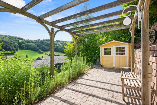 patio / terrace featuring a storage unit, a pergola, and a patio