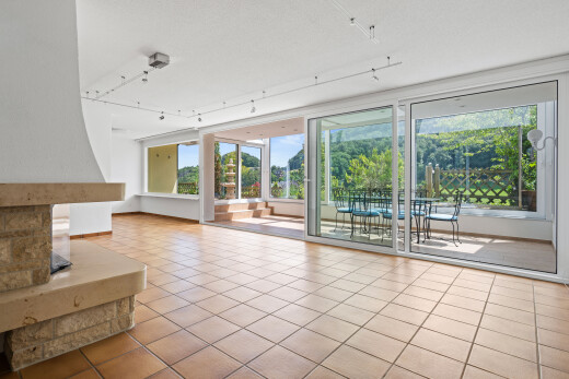 unfurnished living room with track lighting and light tile patterned floors