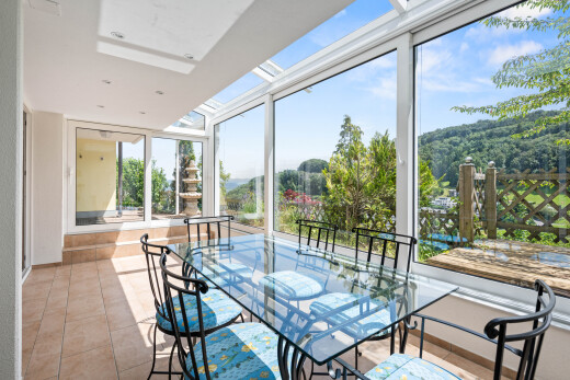 dining area featuring a skylight and light tile patterned floors