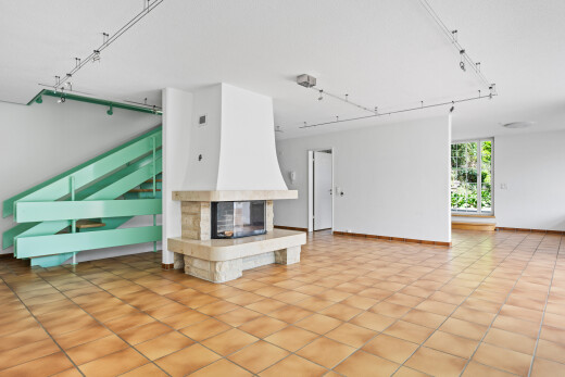 unfurnished living room featuring rail lighting, a multi sided fireplace, and light tile patterned floors