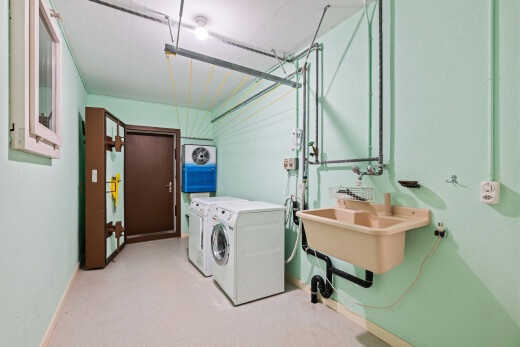 laundry area featuring separate washer and dryer and light colored carpet
