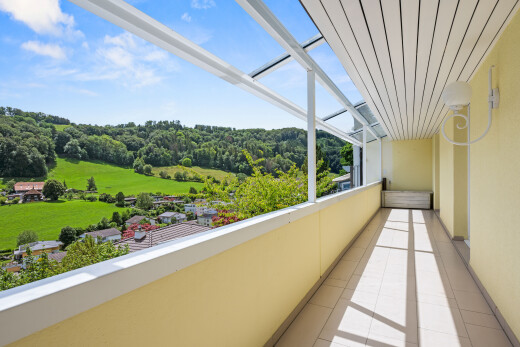 balcony featuring a forest view