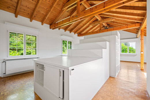 interior space with white cabinetry, light countertops, parquet floors, a wood ceiling with exposed beams, and a peninsula