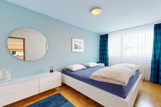 chambre avec cloison sèche, drywall, parquet floor, sol en finition bois, et wood finish floor