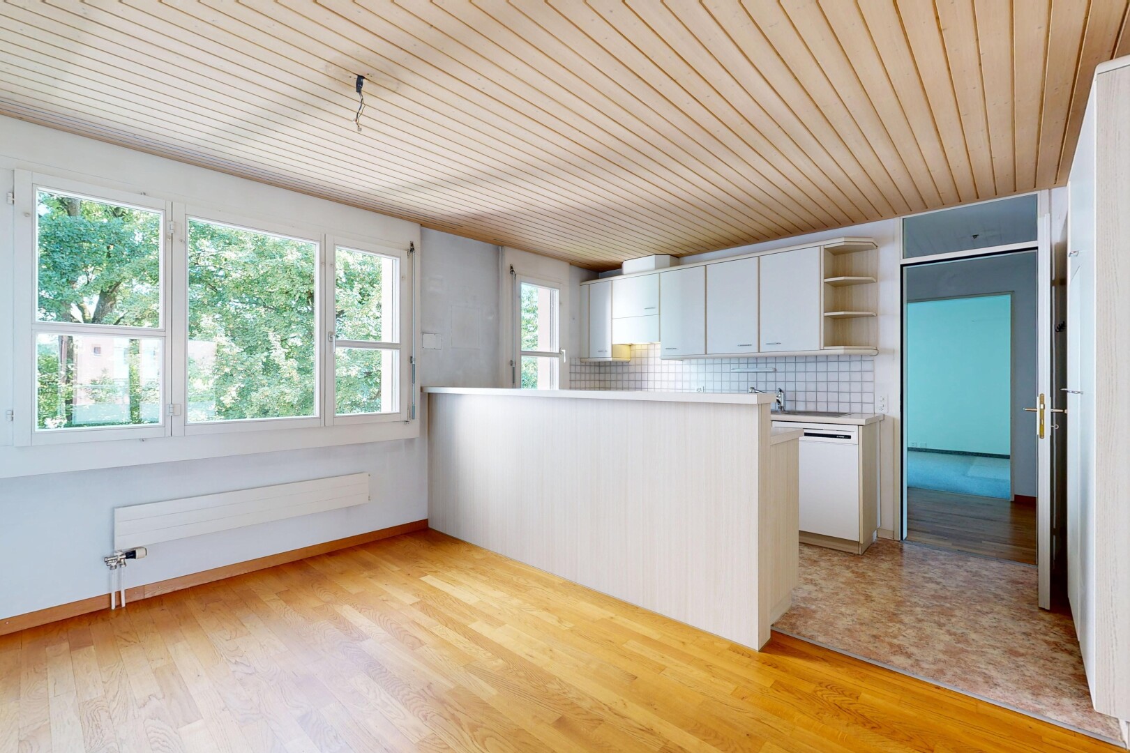 kitchen with a peninsula, light countertops, wood ceiling, decorative backsplash, and light wood-style flooring