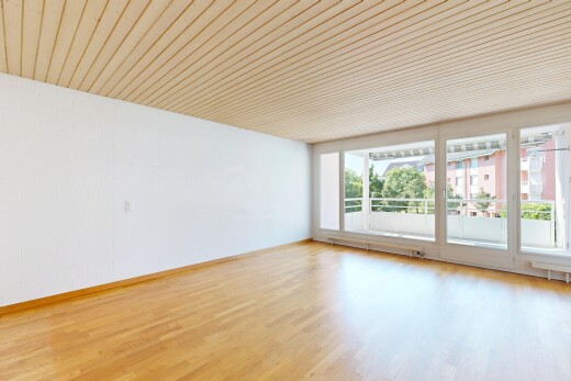 empty room with light wood-style floors and a baseboard heating unit