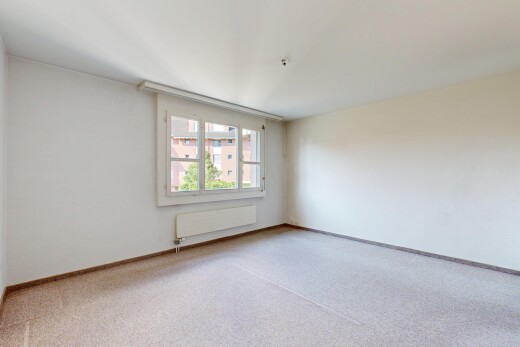 spare room with carpet and radiator heating unit