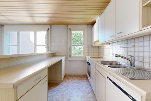 kitchen with light countertops, white dishwasher, white cabinets, wooden ceiling, and light flooring