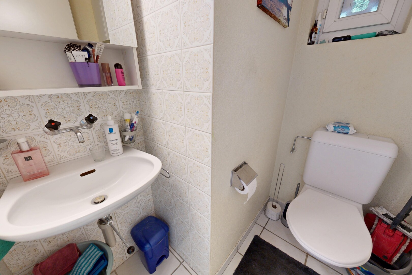 half bath with backsplash and tile walls