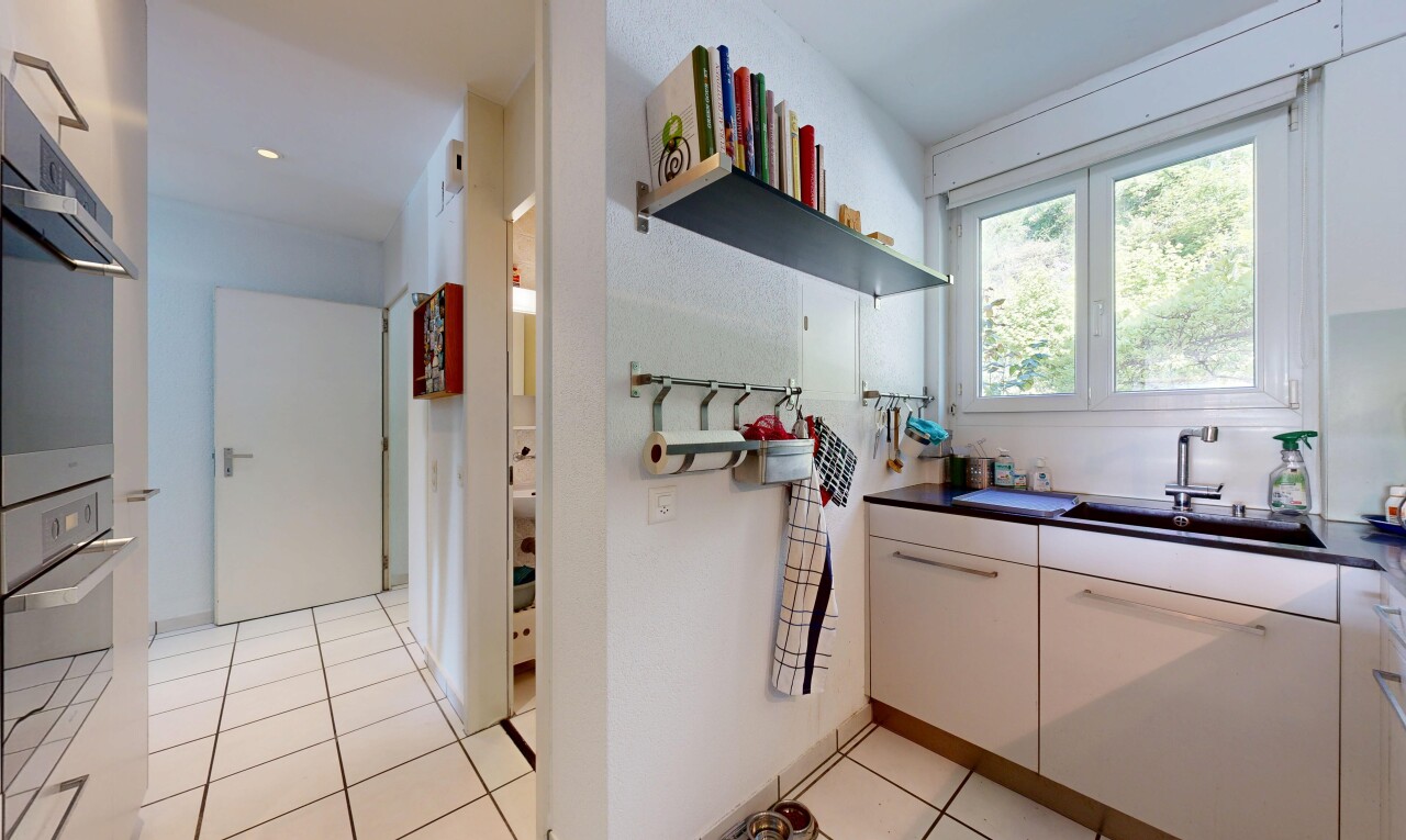 kitchen with white cabinetry, dark countertops, light tile patterned flooring, and open shelves