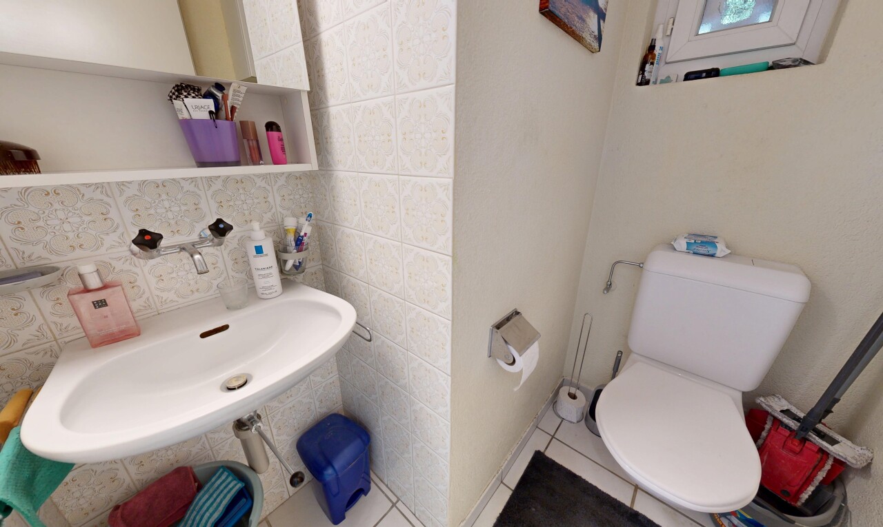 half bath with backsplash and tile walls