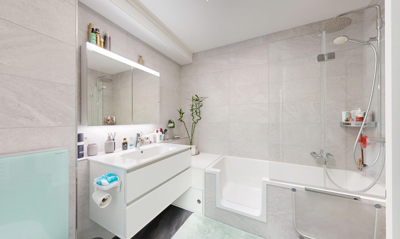 bathroom featuring vanity and tile walls