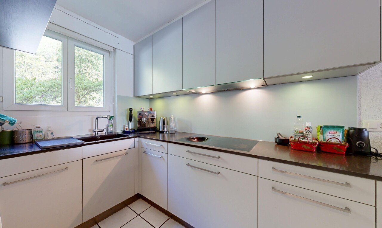 kitchen featuring dark countertops, black electric stovetop, and white cabinets
