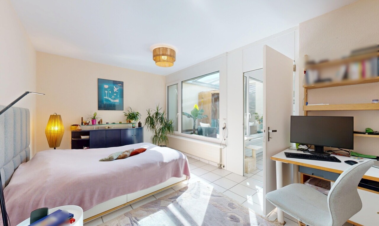 room featuring a desk and light tile patterned floors