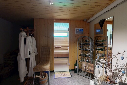 room with wooden walls, carpet, and wooden ceiling