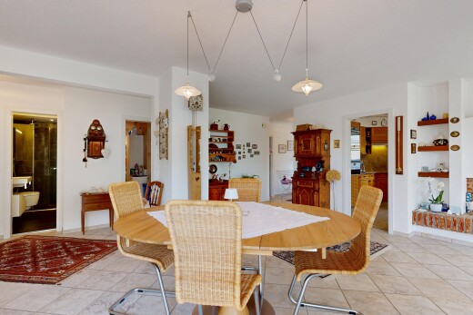 dining room featuring built in shelves and light tile patterned floors