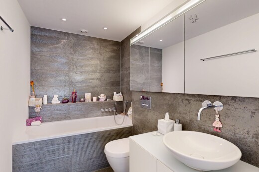 full bathroom featuring tile walls, a garden tub, vanity, and recessed lighting