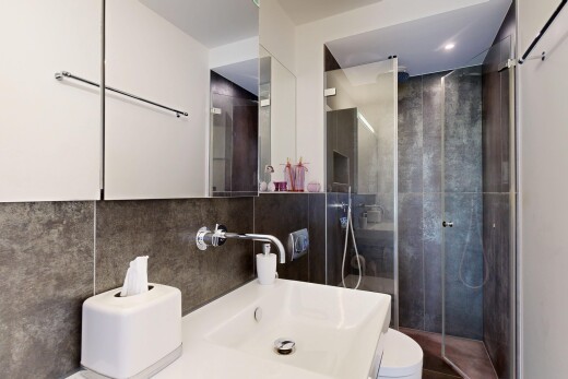full bath with a shower stall, recessed lighting, vanity, tile walls, and decorative backsplash