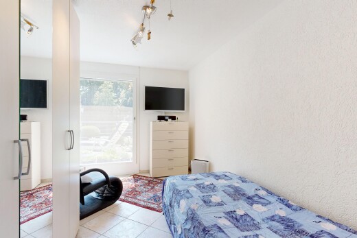 room / bedroom featuring rail lighting and light tile patterned flooring