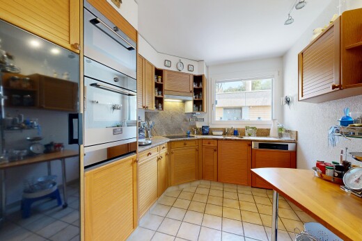 kitchen with light countertops, open shelves, tasteful backsplash, oven, and light tile patterned flooring