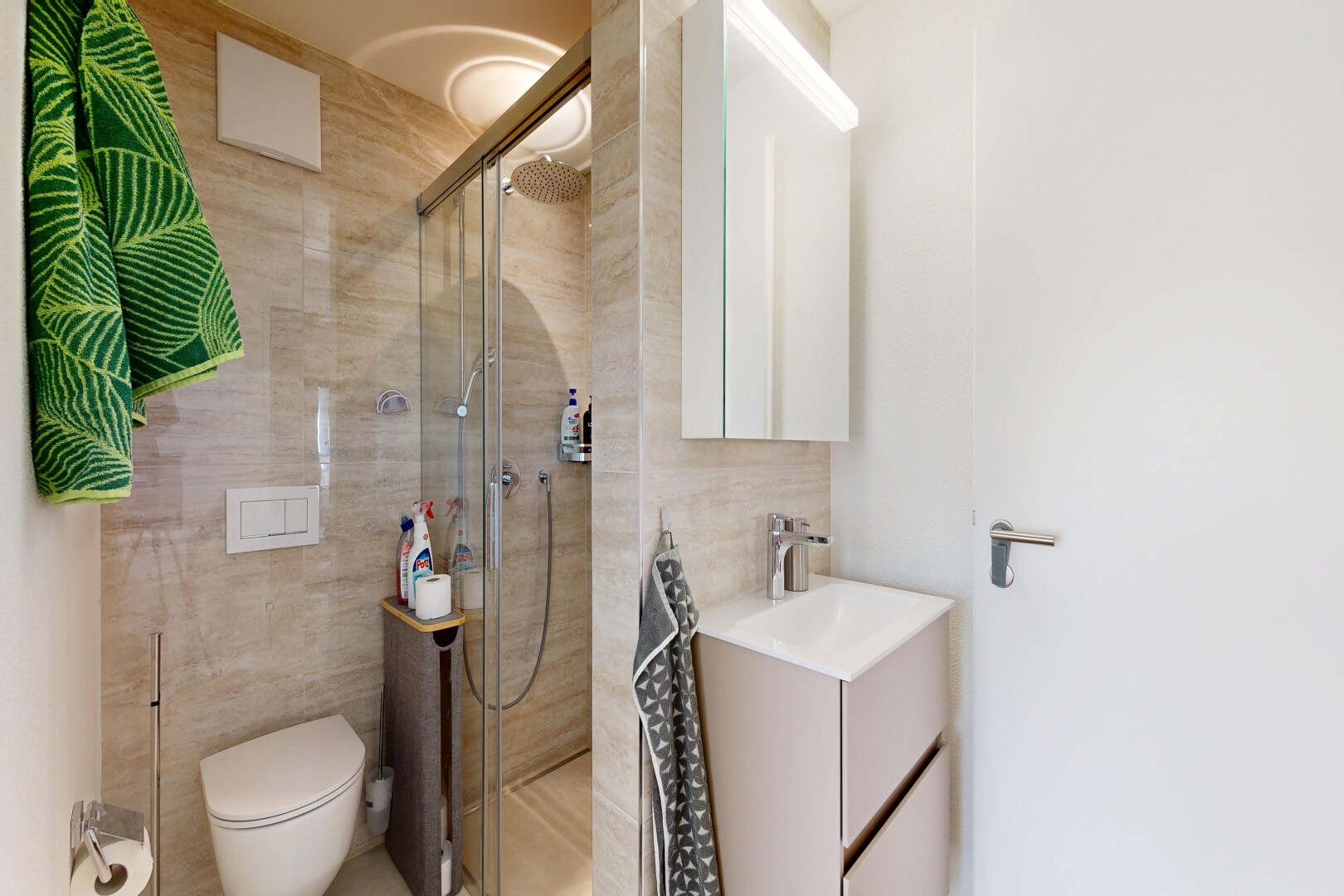 bathroom with vanity, tile walls, and a walk in shower
