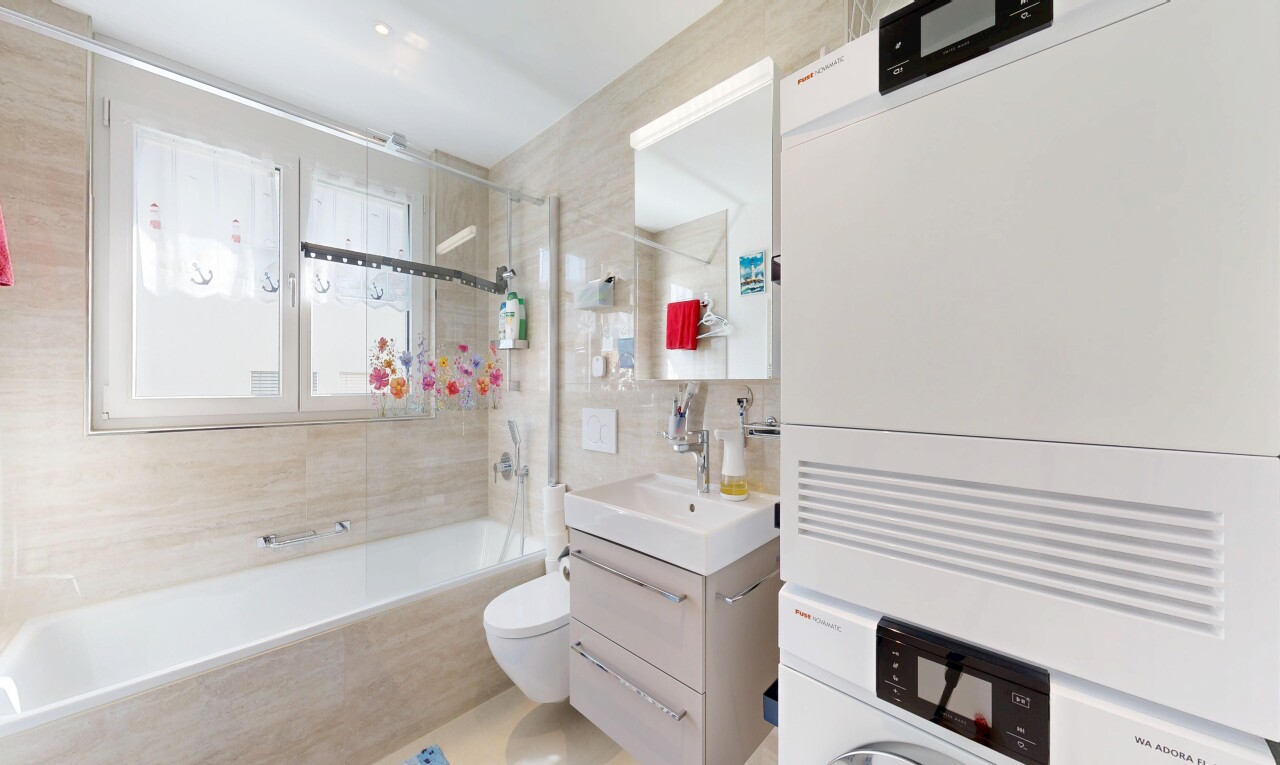 full bathroom featuring vanity, tile walls, and tiled shower / bath combo