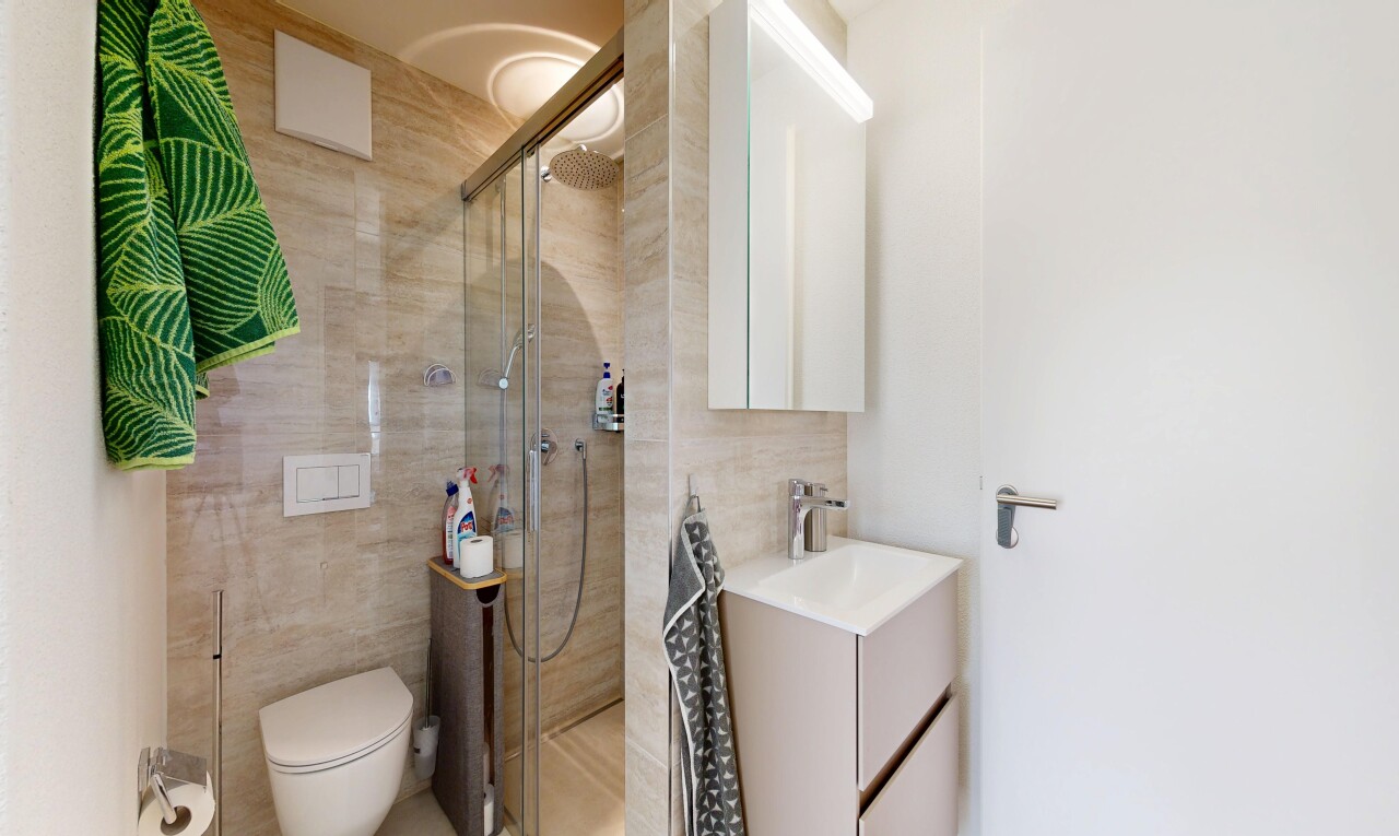 bathroom with vanity, tile walls, and a walk in shower