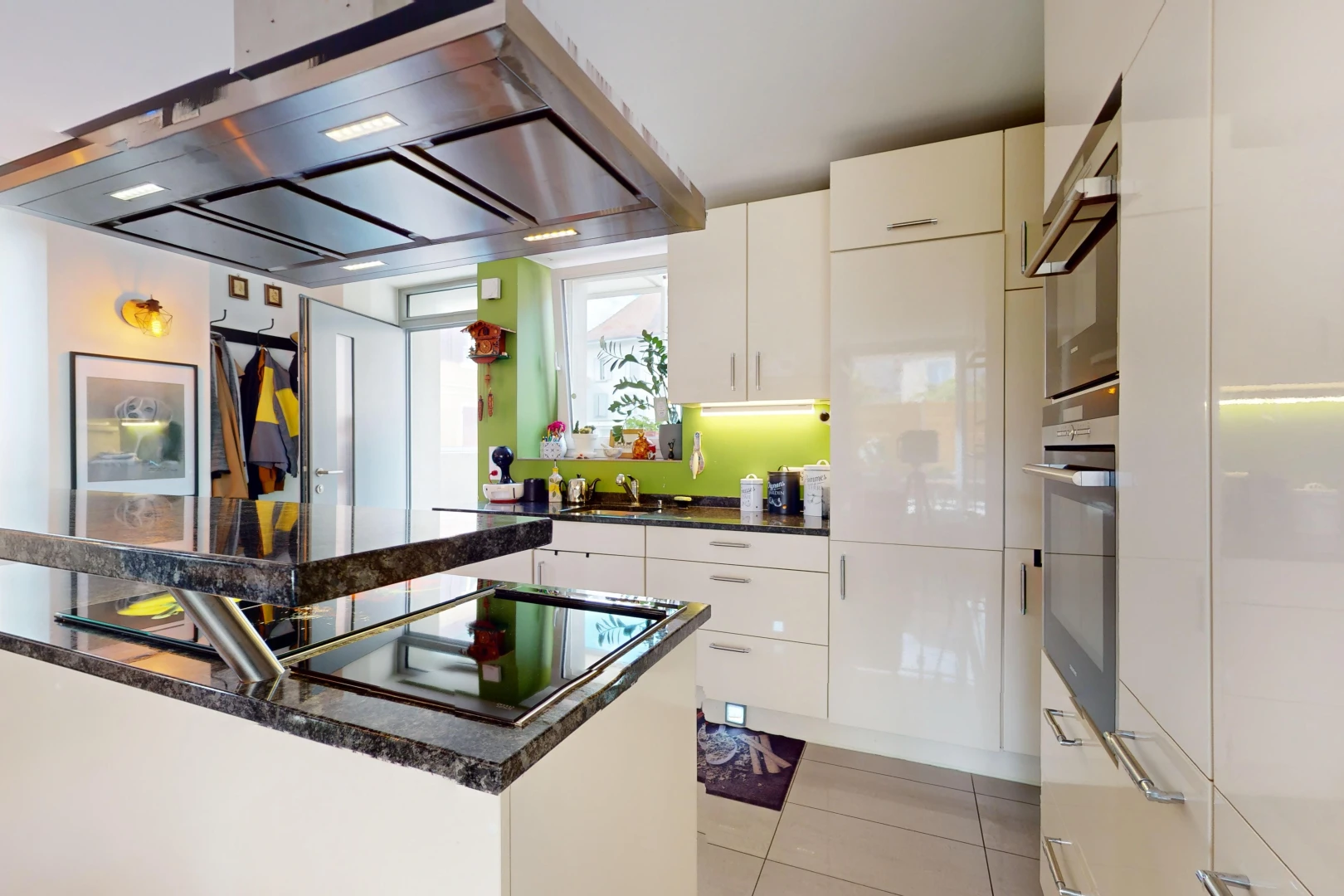 kitchen with white cabinetry, stainless steel oven, light tile patterned floors, and extractor fan
