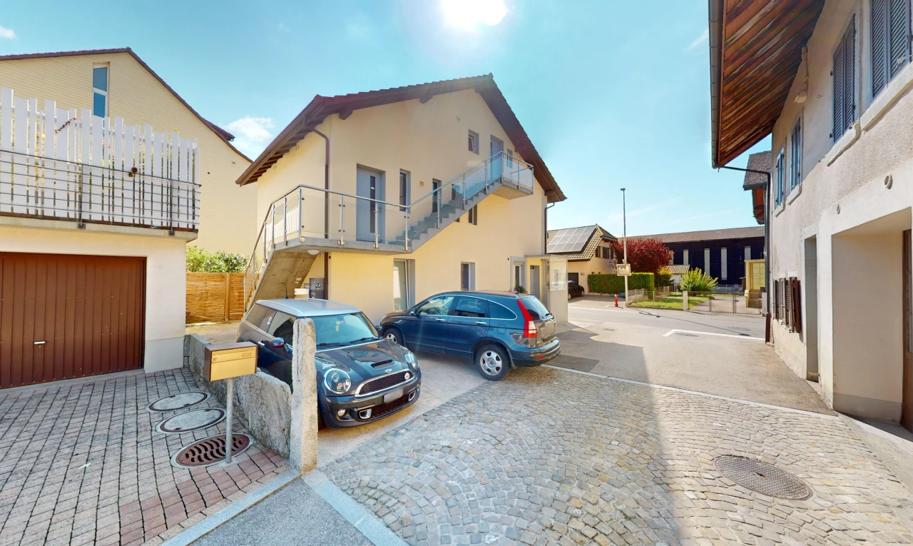 view of home featuring a balcony and a garage