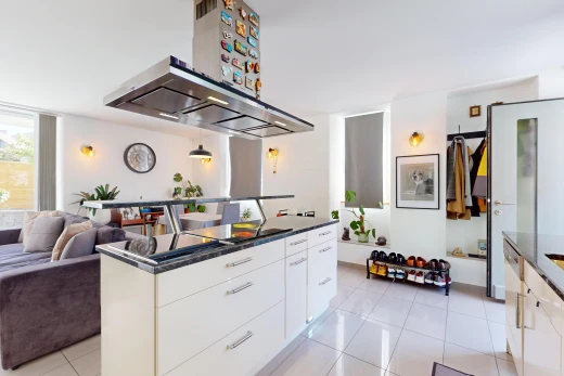 kitchen featuring white cabinets, island exhaust hood, pendant lighting, and light tile patterned floors