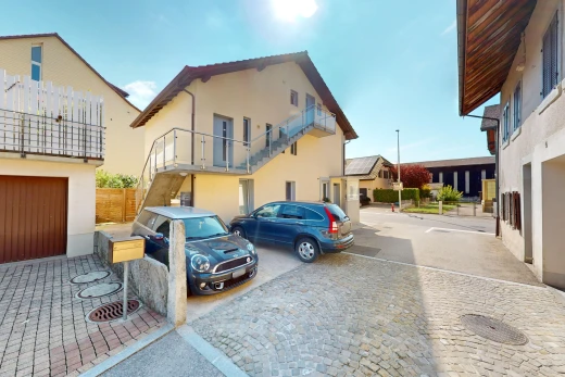 view of home featuring a balcony and a garage