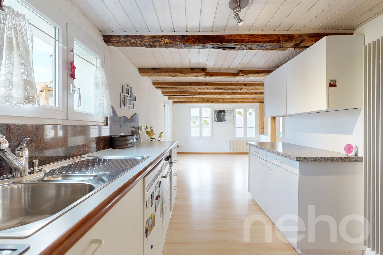 cuisine avec évier, armoires blanches, white cabinets, inside property, et lumière naturelle