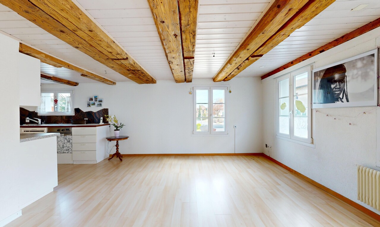 pièce vide avec plafond à poutres, beamed ceiling, inside property, light floor, et sol en finition bois