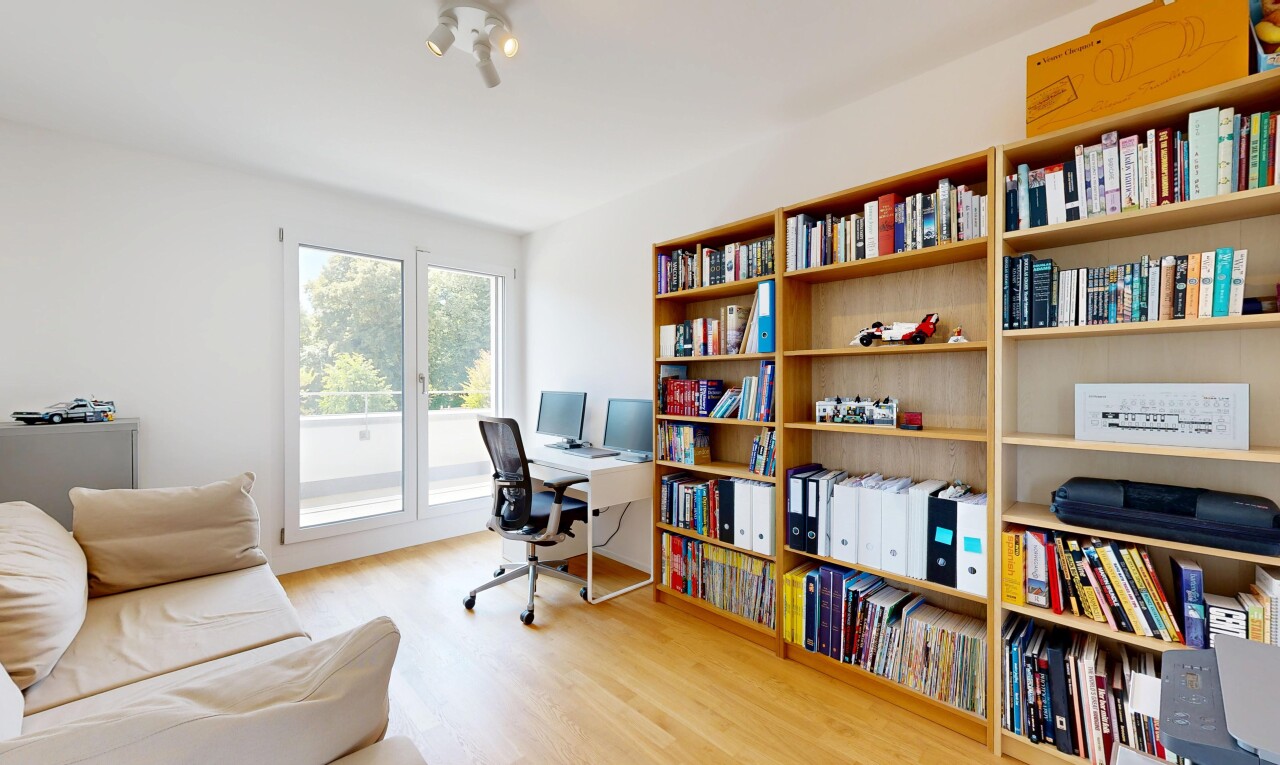 bureau avec sol en finition bois, wood finish floor, cloison sèche, drywall, et télévision