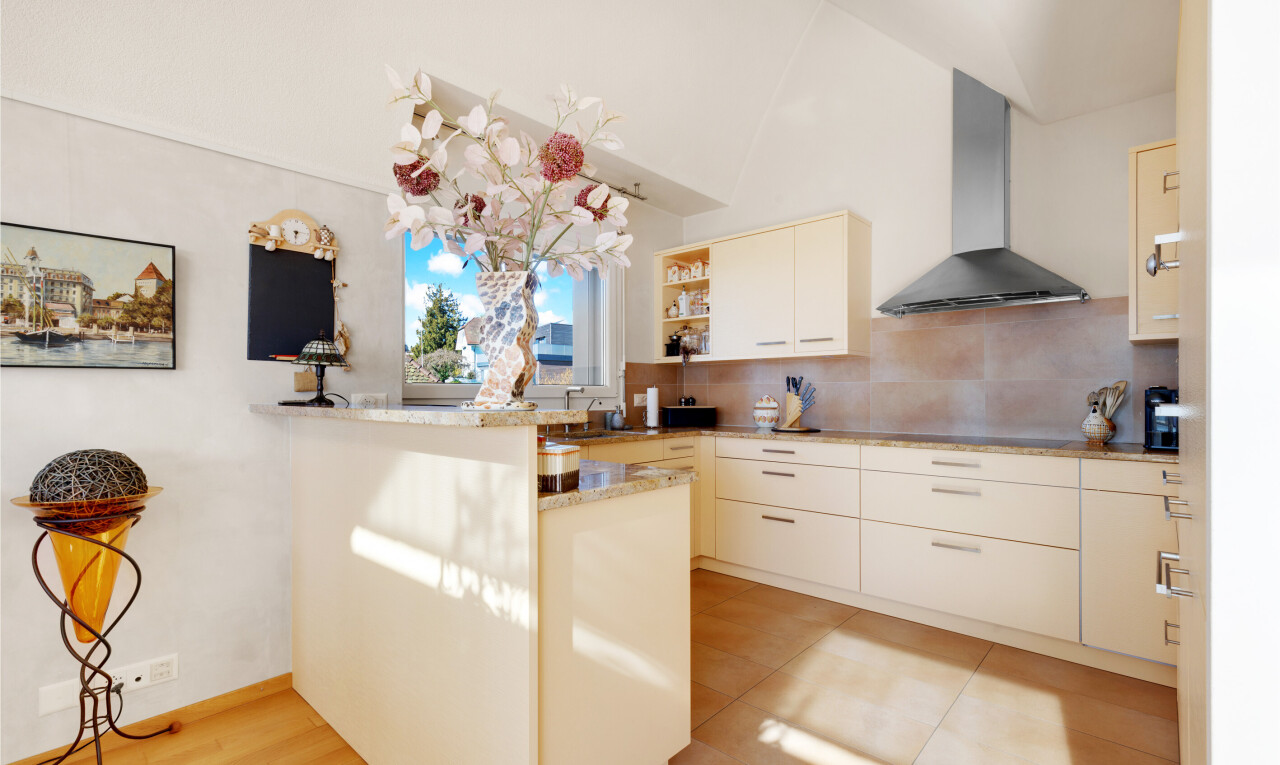 cuisine avec two heights countertops, hotte, cloison sèche, drywall, et péninsule de cuisine